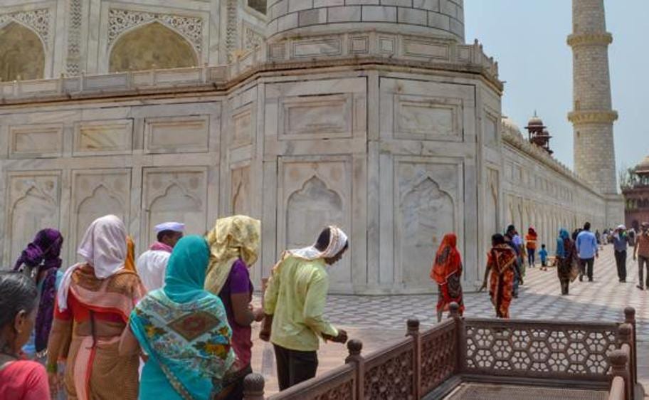 Tourists cover their heads during their visit to the Taj Mahal on a hot summer day, in Agra, Thursday, May 12, 2022. (PTI Photo) Tourists cover their heads during their visit to the Taj Mahal on a hot summer day, in Agra, Thursday, May 12, 2022. (PTI Photo)