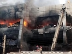 Firefighters try to douse the fire that broke out in a building near Mundka metro station, in New Delhi on Friday. (ANI)