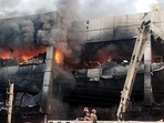 Firefighters try to douse the fire that broke out in a building near Mundka metro station, in New Delhi on Friday. (ANI)