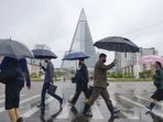 People wearing protective face masks walk amid concerns over the new coronavirus disease (Covid-19) in Pyongyang, North Korea.