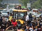 Locals stage a protest in front of an MCD bulldozer at Shaheen Bagh area during an anti-encroachment drive, in New Delhi, on Monday. Locals stage a protest in front of an MCD bulldozer at Shaheen Bagh area during an anti-encroachment drive, in New Delhi, on Monday.