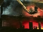 Fire officials try to douse a fire in a four storied building, in New Delhi.