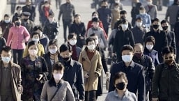 FILE PHOTO: People wearing protective face masks commute amid concerns over the new coronavirus disease (COVID-19) in Pyongyang, North Korea.