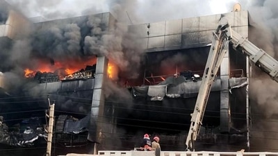 Firefighters try to douse the fire that broke out in a building near Mundka metro station, in New Delhi on Friday. (ANI) Firefighters try to douse the fire that broke out in a building near Mundka metro station, in New Delhi on Friday. (ANI)