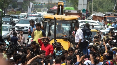 Locals stage a protest in front of an MCD bulldozer at Shaheen Bagh area during an anti-encroachment drive, in New Delhi, on Monday. (PTI) Locals stage a protest in front of an MCD bulldozer at Shaheen Bagh area during an anti-encroachment drive, in New Delhi, on Monday. (PTI)