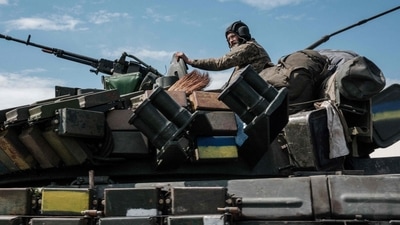 A Ukrainian soldier sits on a tank carryied by a transporter near Bakhmut, eastern Ukraine, on May 12, 2022. (AFP)