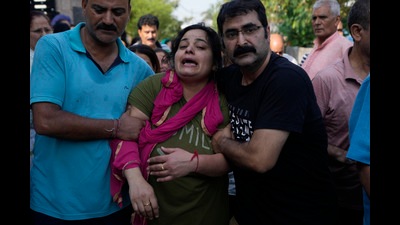 Rahul Bhat’s wife and daughter, who were putting up with him at Sheikhpora migrant colony in Budgam, accompanied the body as it arrived here from Kashmir. (AP)