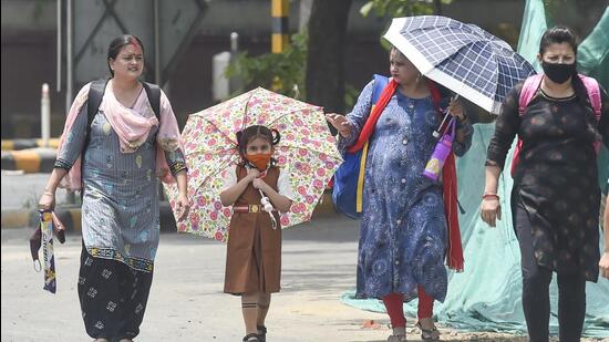 New Delhi, India - May 13, 2022: Pedestrians on a hot summer day at Mandi House area in New Delhi, India, on Friday, May 13, 2022. (Photo by Raj K Raj/ Hindustan Times) (Hindustan Times)