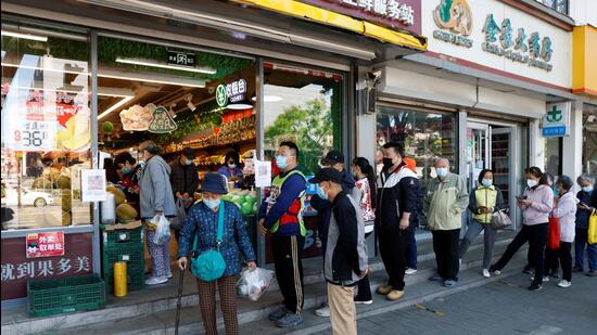 People wearing masks wait in line to enter a vegetable shop amid the Covid-19 outbreak in Beijing, China , on Friday. (REUTERS) People wearing masks wait in line to enter a vegetable shop amid the Covid-19 outbreak in Beijing, China , on Friday. (REUTERS)