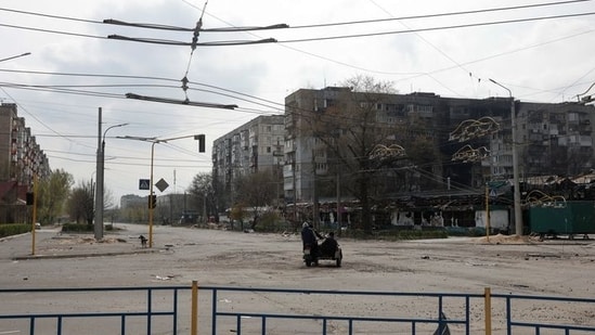 FILE PHOTO: Local residents ride a motorcycle along an empty street with residential buildings damaged by a military strike, as Russia's attack on Ukraine continues, in Sievierodonetsk, Luhansk region.&nbsp;(REUTERS)