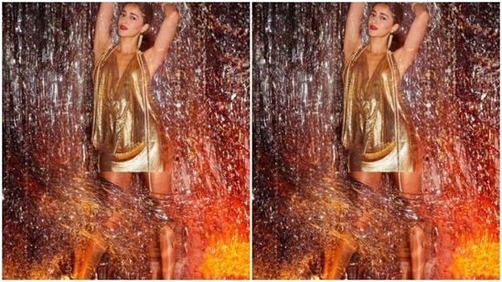 Ananya Panday earlier aced the retro disco look in this golden dazzling halter dress which she teamed with gold earrings.(Instagram/@ananyapanday)