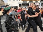 Mourners clash with Israeli security forces during the funeral of slain veteran Al-Jazeera journalist Shireen Abu Akleh in Jerusalem's Old City on May 13, 2022, two days after she was killed while covering an Israeli army raid in the West Bank. (Photo by GIL COHEN-MAGEN / AFP) Mourners clash with Israeli security forces during the funeral of slain veteran Al-Jazeera journalist Shireen Abu Akleh in Jerusalem's Old City on May 13, 2022, two days after she was killed while covering an Israeli army raid in the West Bank. (Photo by GIL COHEN-MAGEN / AFP)