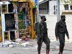 Sri Lankan soldiers walk past a burnt bus near Sri Lanka's former prime minister Mahinda Rajapaksa's official residence, a day after it was torched by protesters in Colombo on May 10, 2022. Sri Lankan soldiers walk past a burnt bus near Sri Lanka's former prime minister Mahinda Rajapaksa's official residence, a day after it was torched by protesters in Colombo on May 10, 2022. 