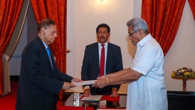President Gotabaya Rajapaksa, right, hands over the appointment document to Gamini Lakshman Peiris after he took oath of office as the new foreign minister in Colombo. (AP)