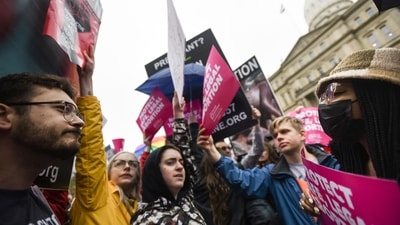 Abortion-rights advocates, right, try to block anti-abortion signage during a rally at the state capitol in Lansing, Michigan. (AP) Abortion-rights advocates, right, try to block anti-abortion signage during a rally at the state capitol in Lansing, Michigan. (AP)