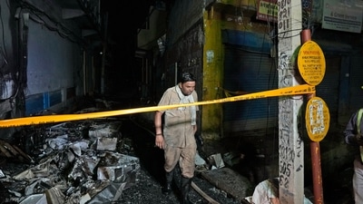 Delhi Mundka fire: A fire official returns after controlling a fire in a four storied building, (AP) Delhi Mundka fire: A fire official returns after controlling a fire in a four storied building, (AP)