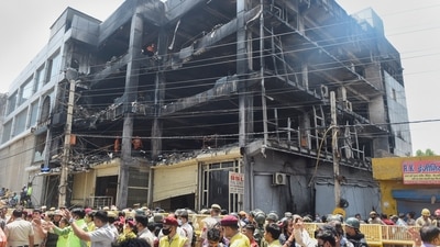 Journalists, security personnel and civil defence officials at the site, as NDRF personnel carry out rescue and relief work after a massive fire at an office building near the Mundka Metro Station, in West Delhi. (PTI) Journalists, security personnel and civil defence officials at the site, as NDRF personnel carry out rescue and relief work after a massive fire at an office building near the Mundka Metro Station, in West Delhi. (PTI)