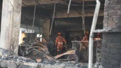 The fire reportedly broke out at the first floor of the building that housed the office of a firm that manufactures CCTV cameras and Wi-Fi routers, officials said. (Raj K Raj/Hindustan Times)