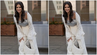 Harnaaz paired the crop top with an oversized white button-down silk satin shirt featuring long sleeves with large cuffs, an open front, droopy sleeves and a patch pocket. A pair of matching high-rise pants with flared hem, pleats and pockets completed the ensemble. (Instagram/@harnaazsandhu_03) Harnaaz paired the crop top with an oversized white button-down silk satin shirt featuring long sleeves with large cuffs, an open front, droopy sleeves and a patch pocket. A pair of matching high-rise pants with flared hem, pleats and pockets completed the ensemble. (Instagram/@harnaazsandhu_03)