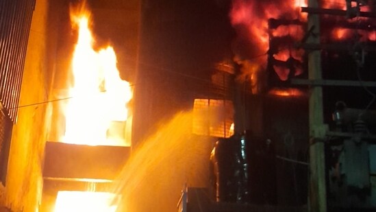 Fire-fighting operations underway at a plastic factory in Delhi's Narela area.(HT Photo)