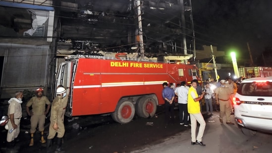 Fire Brigade personnel at rescue and relief work after a massive fire at an office building near the Mundka Metro Station, in West Delhi, in the wee hours of Saturday, May 14, 2022.(PTI)