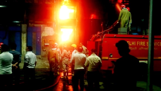 Firefighters try to douse a fire that broke at a plastic granulation factory at Narela, in New Delhi, Saturday, May 14, 2022. (PTI Photo)