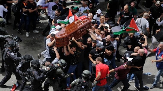 Israeli police confront with mourners as they carry the casket of slain Al Jazeera veteran journalist Shireen Abu Akleh during her funeral in east Jerusalem, Friday, May 13, 2022.&nbsp;(AP)