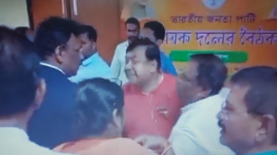 BJP leader Ram Prasad Pal being pacified by party leaders after Biplab Deb resigned as Tripura chief minister.(Twitter/AITC Tripura)
