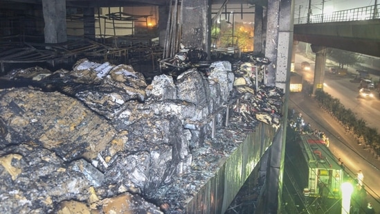 The building which has been engulfed in fire had a car showroom and office spaces. It is close to the Mundka metro station.(Sanchit Khanna/Hindustan Times)