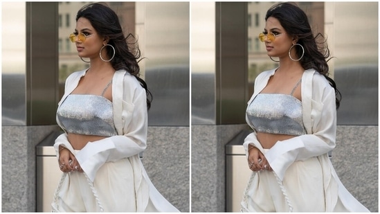 The 22-year-old beauty queen chose minimal accessories to style the all-white and silver ensemble. She went for tinted vintage sunglasses, silver hoop earrings, silver statement rings, a bracelet, matching high heels and a quirky white mini shoulder bag. In the end, Harnaaz rounded it all off with open tresses and dewy make-up.(Instagram/@harnaazsandhu_03)