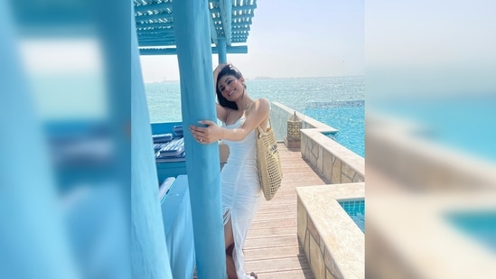 Mouni Roy teamed her simple yet stylish beach wear with a beige tote bag from the luxury brand Prada.(Instagram/@imouniroy)