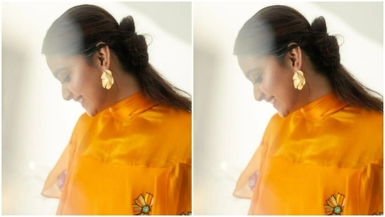 Styled by fashion stylist Archa Mehta, Keerthy wore her tresses into a messy bun with a middle part.(Instagram/@keerthysureshofficial)