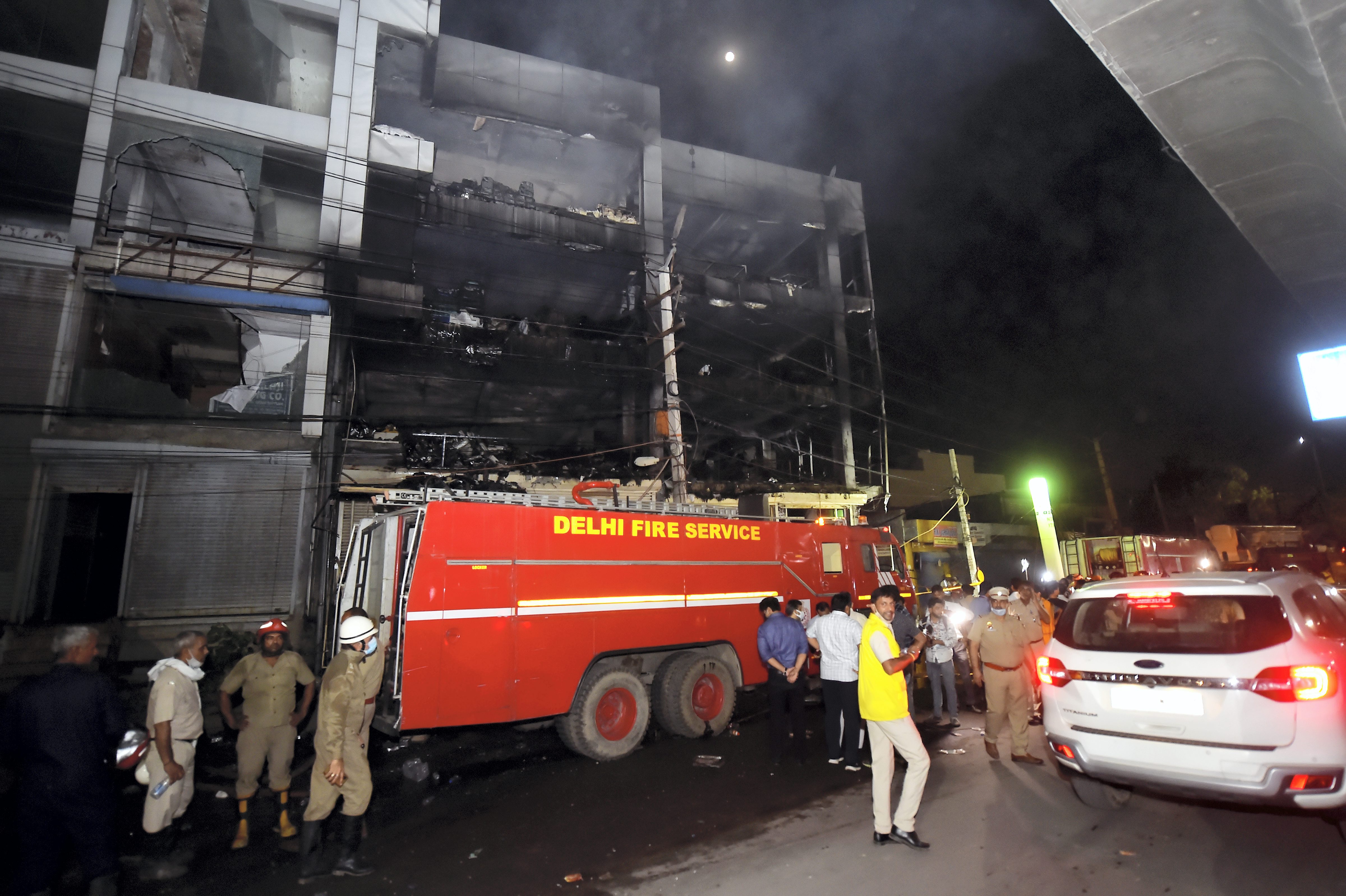 Fire Brigade personnel at rescue and relief work after a massive fire at an office building near the Mundka Metro Station, in West Delhi, in the wee hours of Saturday, May 14, 2022. (PTI)