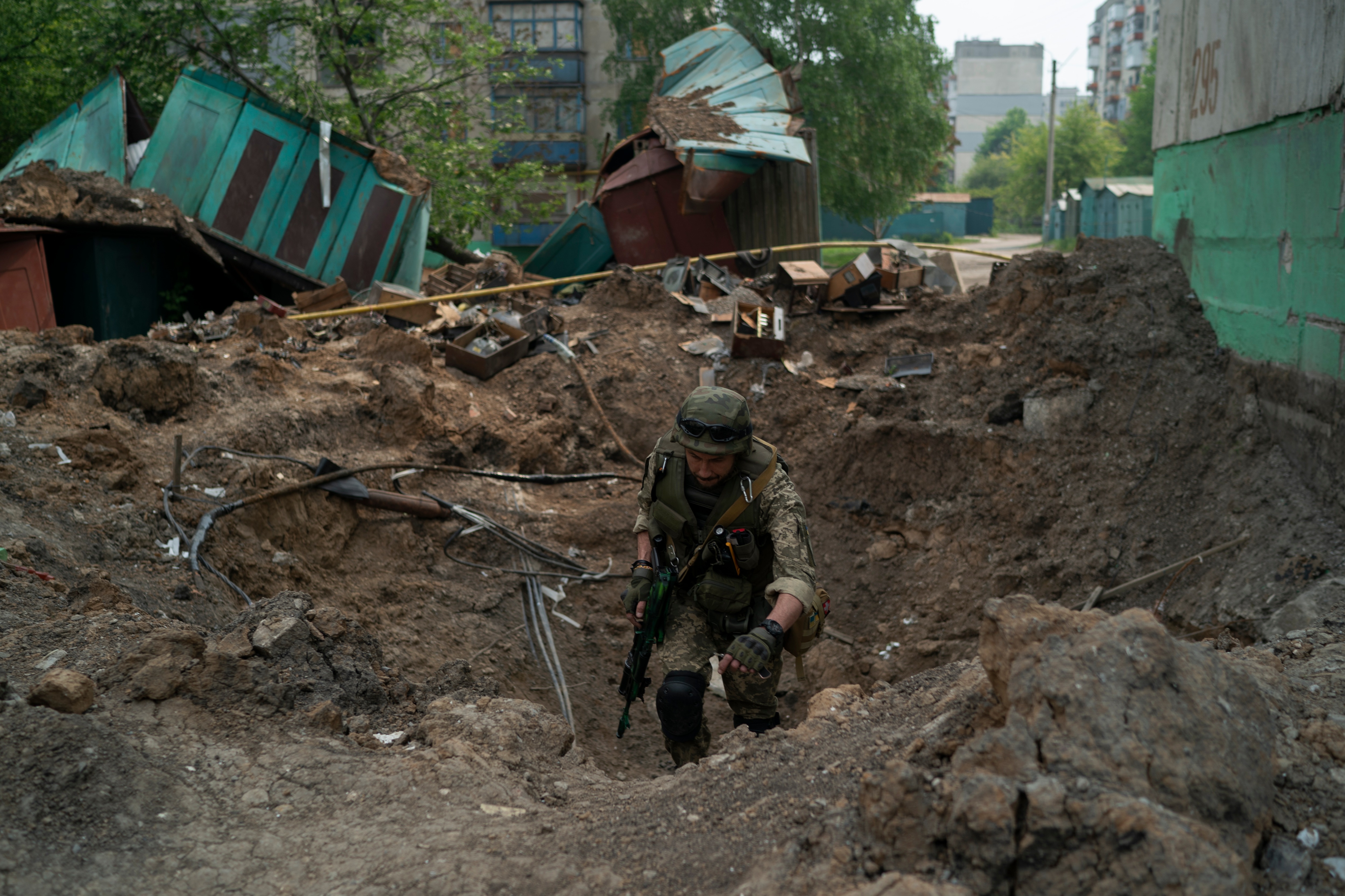 A special task force policeman inspects a site after an airstrike by Russian forces in Lysychansk, Luhansk region, on May 13, 2022.&nbsp; (AP)