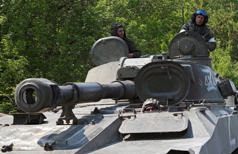 Service members of pro-Russian troops are seen atop a self-propelled howitzer outside Donetsk, Ukraine, on May 13, 2022.&nbsp; (Reuters Photo)