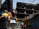 Forensic experts visit to collect the samples from the four-storey building that caught a massive fire, near Mundka Metro Station, in New Delhi on Sunday. (ANI Photo)