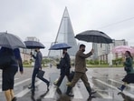 People wearing protective face masks walk amid concerns over the new coronavirus disease (Covid-19) in Pyongyang, North Korea.