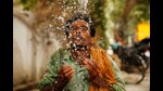 An Indian worker splashes water on his face to cool himself on a hot summer afternoon in Prayagraj, Uttar Pradesh, India, June 13 (AP)