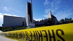 Crime scene tape is stretched across an area at Geneva Presbyterian Church in Laguna Woods, California, after a fatal shooting.