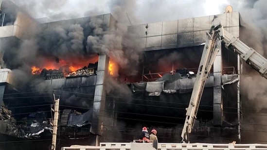 Firefighters try to douse the fire that broke out in a building near Mundka metro station, in New Delhi on Friday. (ANI)