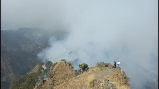 Smoke billows from the forest near Kasauli air force station in Himachal’ Solan district on Sunday. (HT Photo)