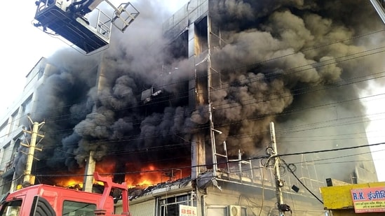 Flames and Smoke billow after a fire broke out in a building near Mundka metro station, in New Delhi on Friday.&nbsp;(ANI)