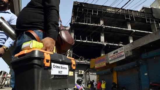 Forensic experts visit to collect the samples from the four-storey building that caught a massive fire, near Mundka Metro Station, in New Delhi on Sunday. (ANI Photo)(Sanjay Sharma)