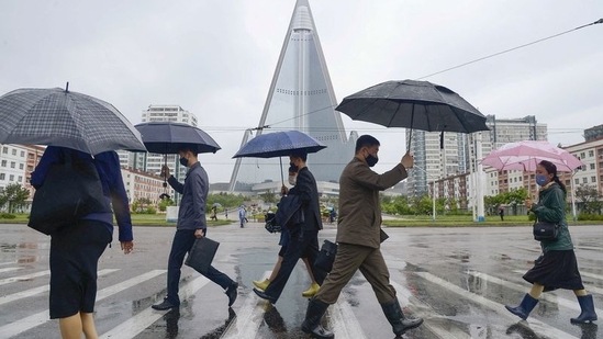 People wearing protective face masks walk amid concerns over the new coronavirus disease (Covid-19) in Pyongyang, North Korea.(REUTERS)
