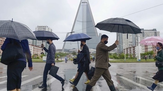 People wearing protective face masks walk amid concerns over Covid-19 in Pyongyang, North Korea.&nbsp;(Reuters file photo)