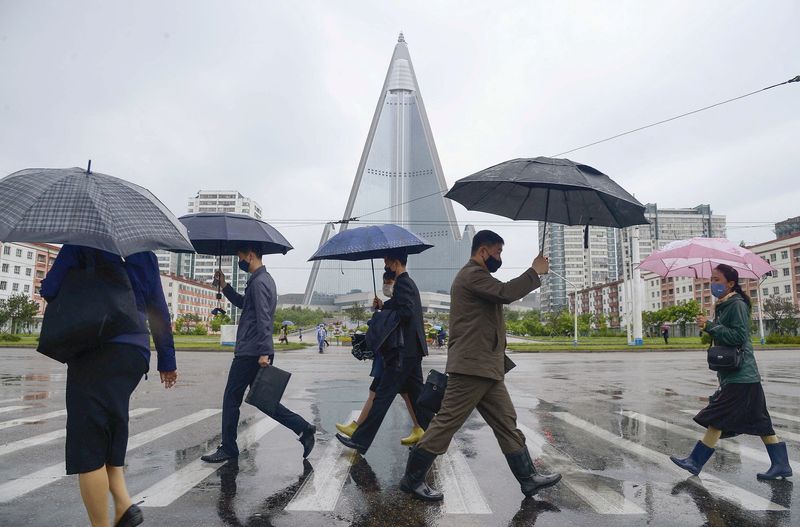 People wearing protective face masks walk amid concerns over Covid-19 in Pyongyang, North Korea.&nbsp; (Reuters file photo)