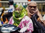 Commuters use scarves to shield themselves from the heat while riding a two-wheeler in Prayagraj. (PTI) Commuters use scarves to shield themselves from the heat while riding a two-wheeler in Prayagraj. (PTI)