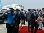 Nepal's Prime minister Sher Bahadur Deuba (C) is greeted by officials upon his arrival at the newly built Gautam Buddha International Airport following its inauguration in Siddharthanagar on May 16, 2022.  (Photo by Prakash MATHEMA / AFP)