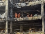 National Disaster Response Force (NDRF) personnel clear the charred debris from a burnt floor a day after a fire broke out in a commercial building at Mundka, New Delhi. (HT PHOTO.)(HT_PRINT) National Disaster Response Force (NDRF) personnel clear the charred debris from a burnt floor a day after a fire broke out in a commercial building at Mundka, New Delhi. (HT PHOTO.)(HT_PRINT)