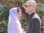 Kourtney and Travis are seen in their wedding looks from the Sunday ceremony. Kourtney and Travis are seen in their wedding looks from the Sunday ceremony.